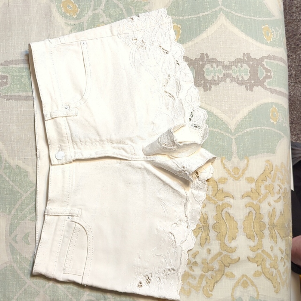 Women's size 12 white denim shorts with cutouts around leg